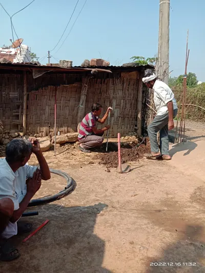 Stand-post tap being fitted in a village