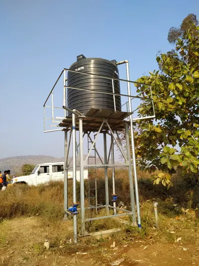 Water tank on a galvanised steel stand with a ladder
