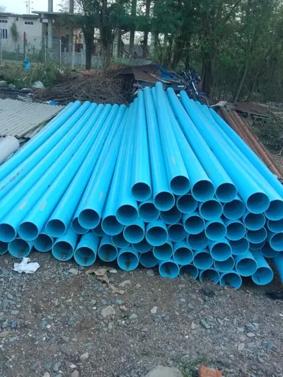 Stack of blue PVC pipes ready for laying village water lines